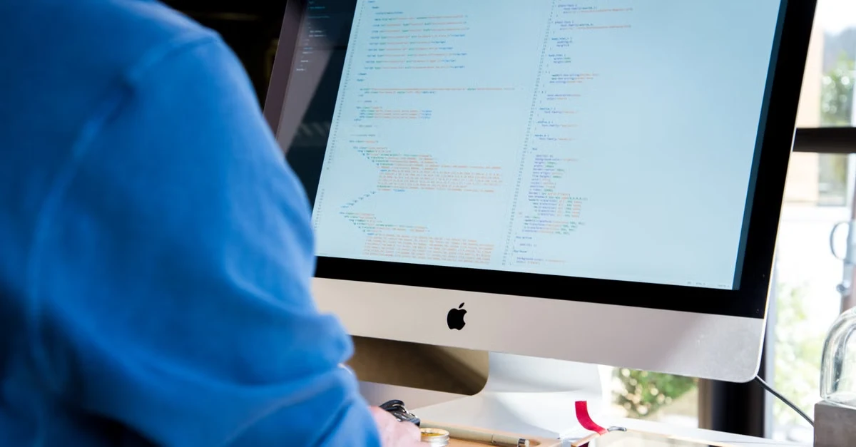 Developer viewing Amazon SEO code and algorithm structure on monitor screen.