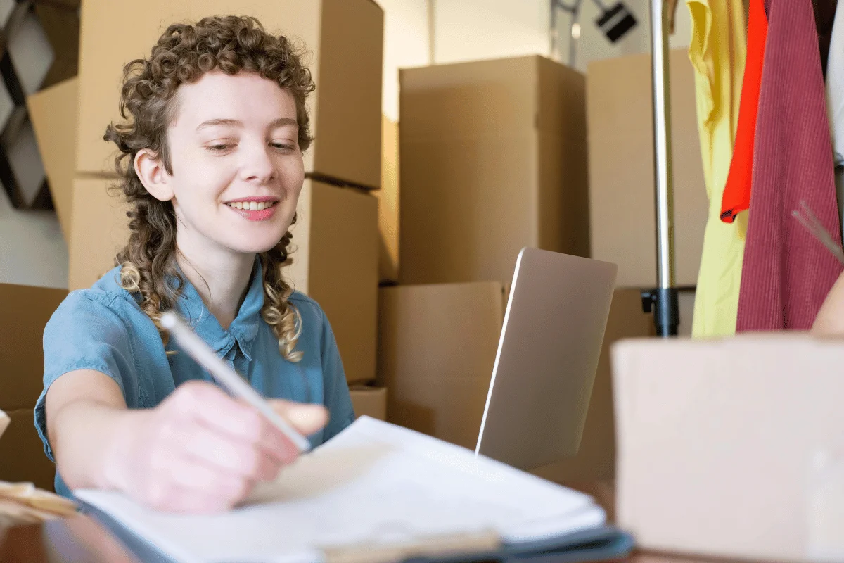 Curly-haired lady enjoys e-commerce work.